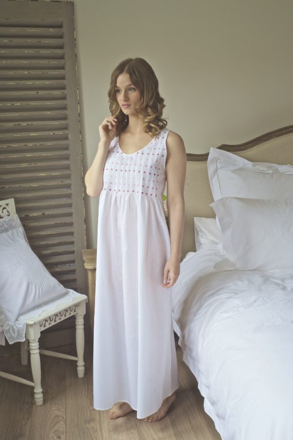 The Pink Lizzie cotton nightie is a Victorian style nightdress is inspired by the designs from the past. Full length with a round neck, comfortable high back and generous sized arm holes for comfort in bed. Delicately embroidered with pink  daisies on the pin tucked bodice and gentle gathers. This fine cotton nightie is very light and ideal for those warm summer months and it is a classic style which suits all ages.
