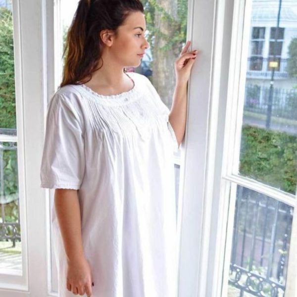 Isla white nightie features attractive pretty embroidery and pin tuck detailing on the front. It has an adorable round neck, with short sleeves that show off the pretty broderie anglaise trim. There is one Mother of Pearl opening button on the collar. This makes a perfect nightdress for maternity or mobility help and is designed for that that ultimate comfort. This white nightie is one of our thicker cotton nighties, which is still breathable and comfortable.