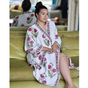 Our luxury waffle bathrobe brings a spa vibe to the bathroom! The robe is printed with a large-scale botanical pattern of deep pinky-red flowers and edged with a pink and green floral border on the cuffs, pocket, and open front and has a matching tie belt. Certainly, a treat for you or your loved one!