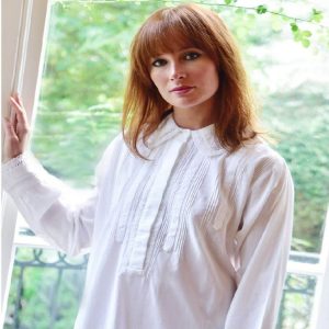 Florence white nightdress is a vintage-inspired shirt style nightdress to transport you back in time! The ‘Florence’ has full-length cuffed sleeves with lace trim and falls to mid-calf. The shirt-style top features a covered placket, very fine pintucks and decorative bands of lace, and the sweet collar is edged with crocheted cotton lace. Our customers praise this white nightdress for being comfortable and generously sized.